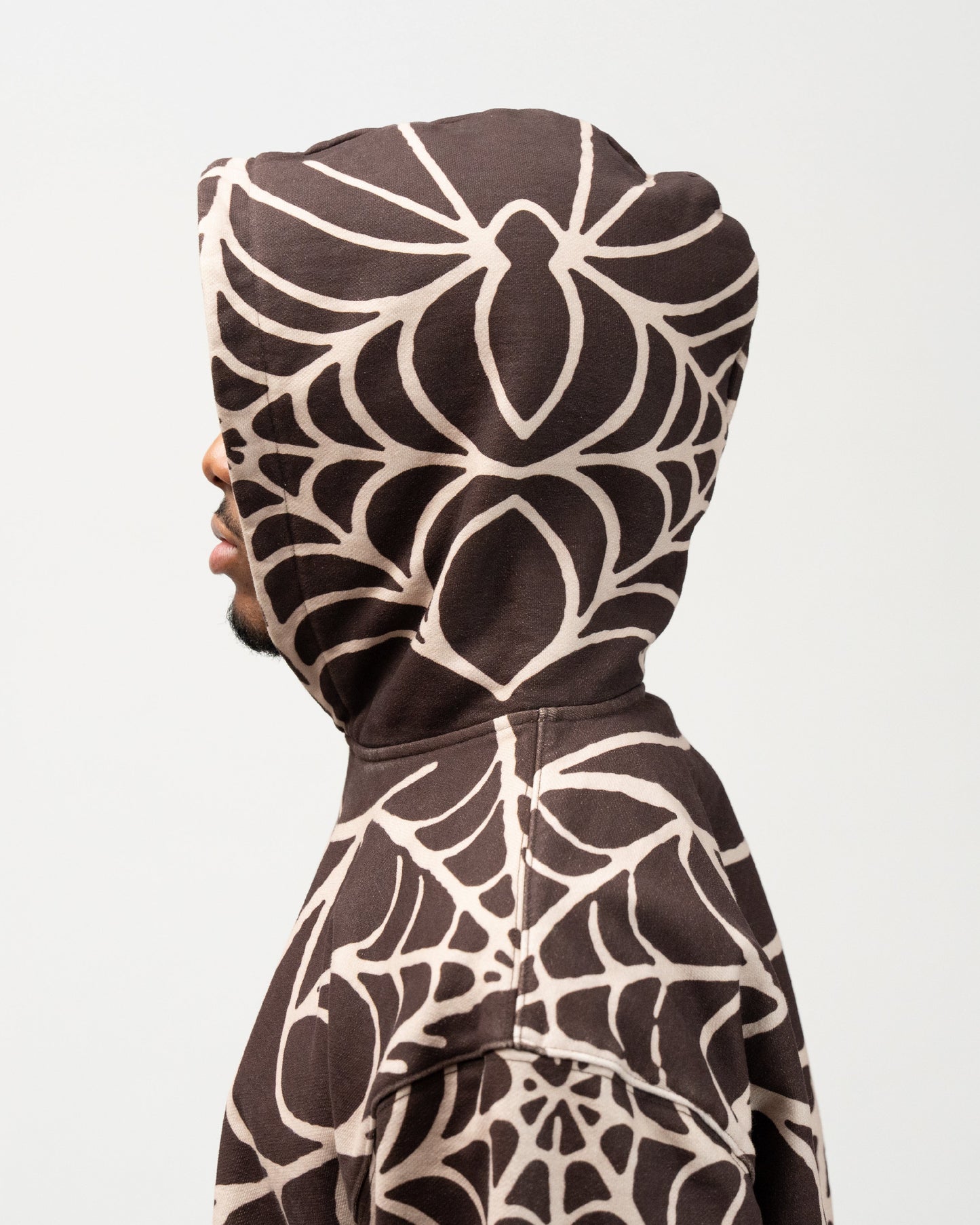 close up side angle of the hood. showcasing the spider print. j3t