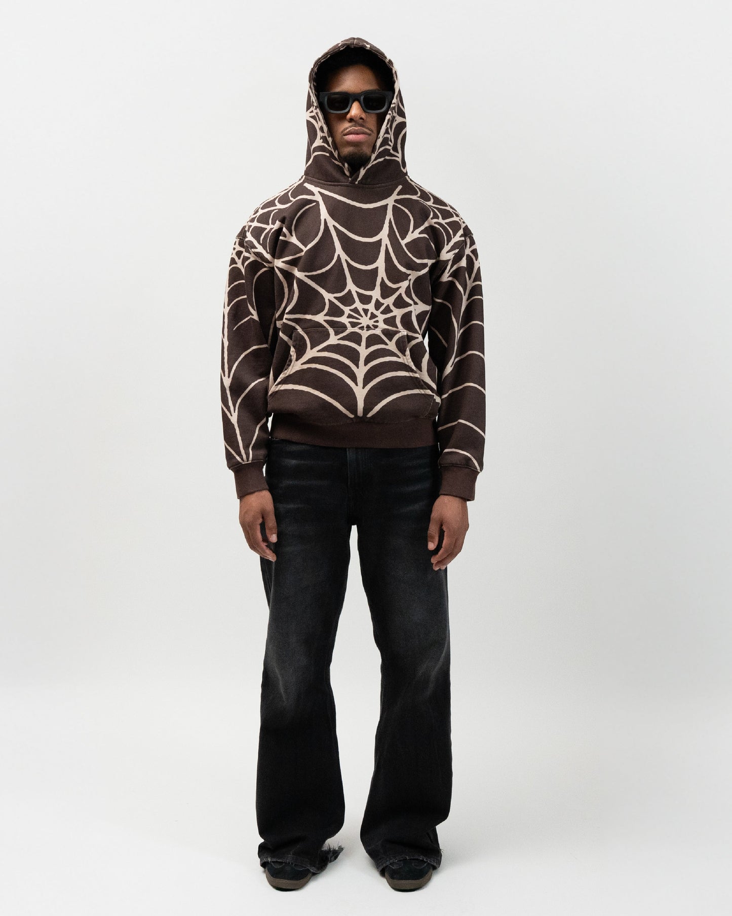 Full body angle of male model wearing the spider hoodie. no pose, hands down by his hip. everythingj3t