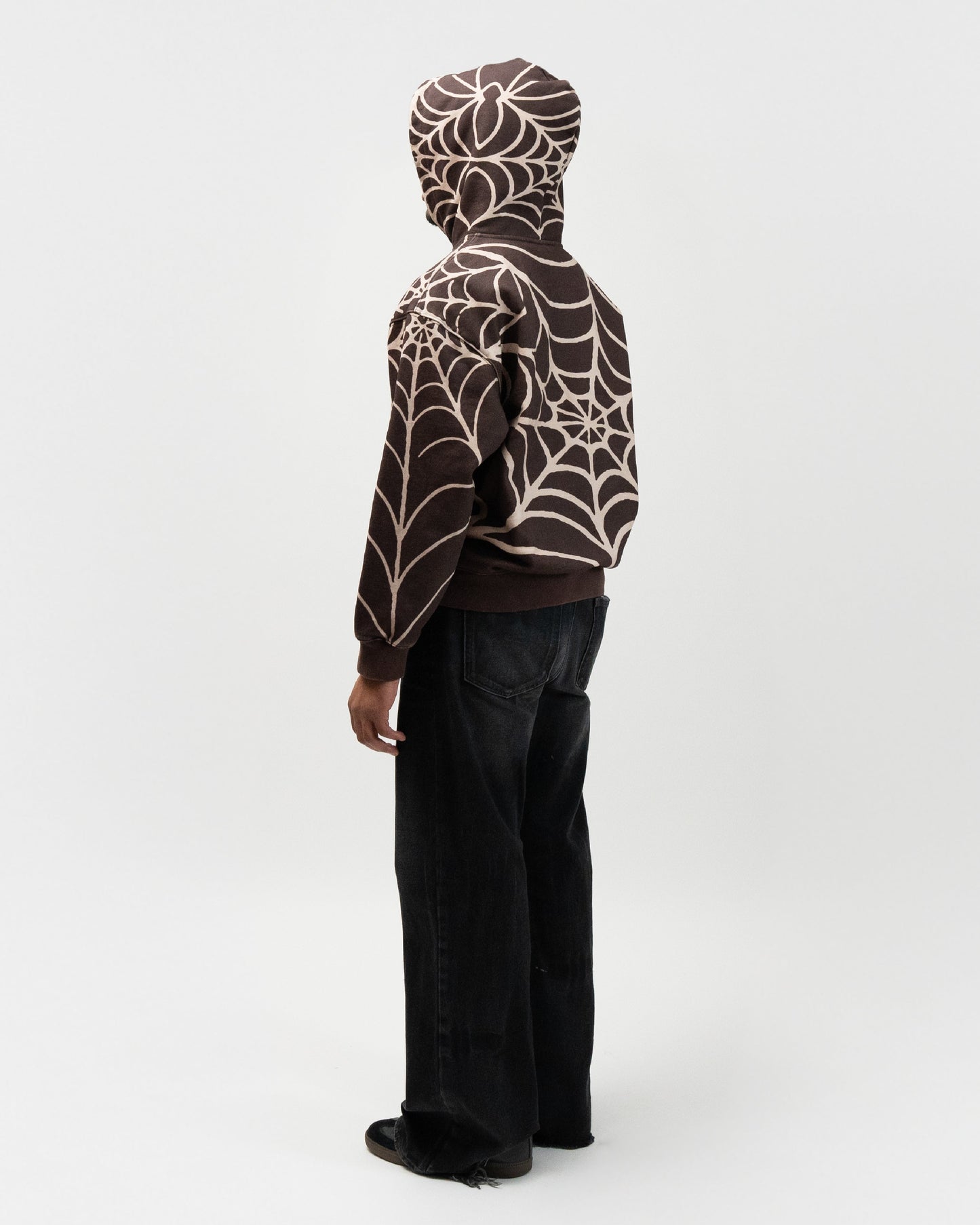 full body rear shot of the angle. His body is turned 45 degrees to the right. j3t spider hoodie