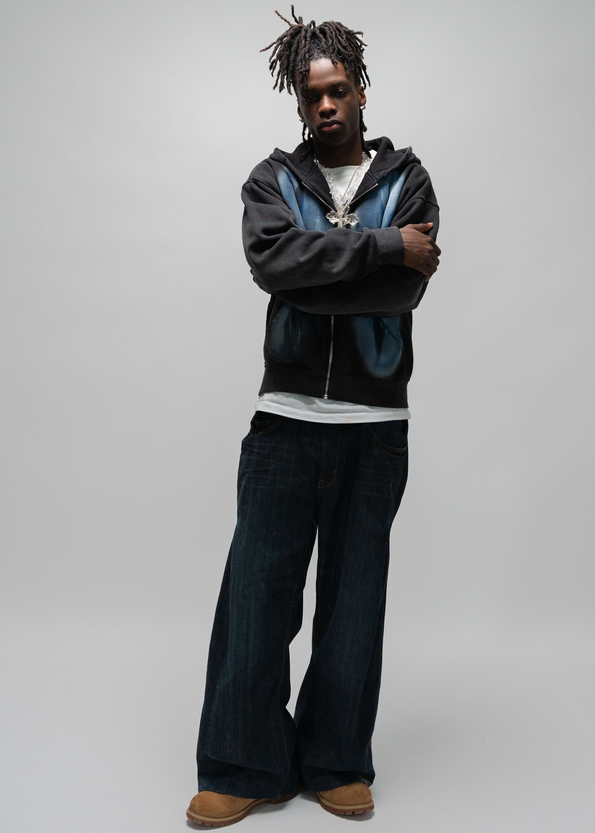 full body posing shot of the model wearing the dogfight zip up by j3t. he has his arms crossed and is leaning to the side a bit. dogfight zip up. jet