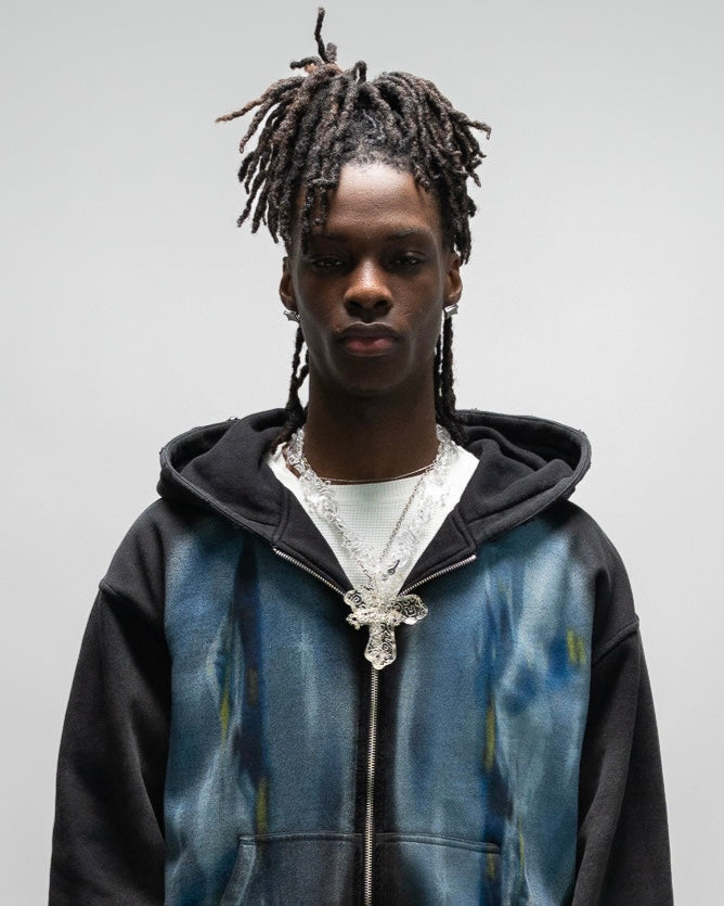 close up of male model wearing the dogfight zip up hoodie by j3t. it has two large oval shaped prints starting from the chest, and ending at the hem. everythingj3t