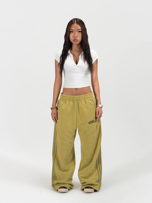 Front facing female model shot of the model wearing the matcha sweats by J3T. She has on a white shirt to complete the fit