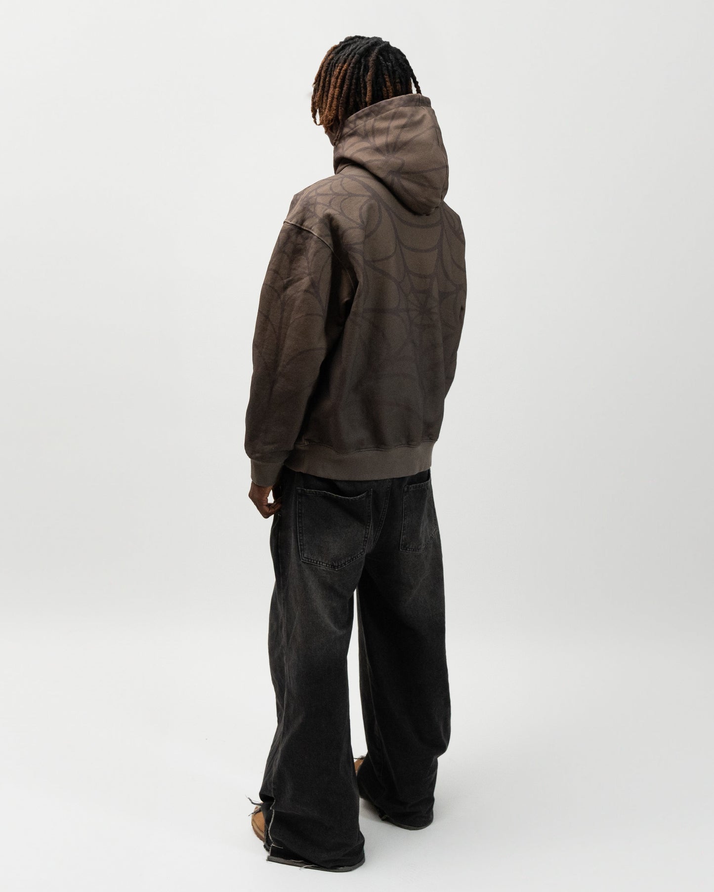 full back angle of the model. he is facing away from the camera. you can see the back of the hoodie and the hoodie. Spider hoodie by j3t