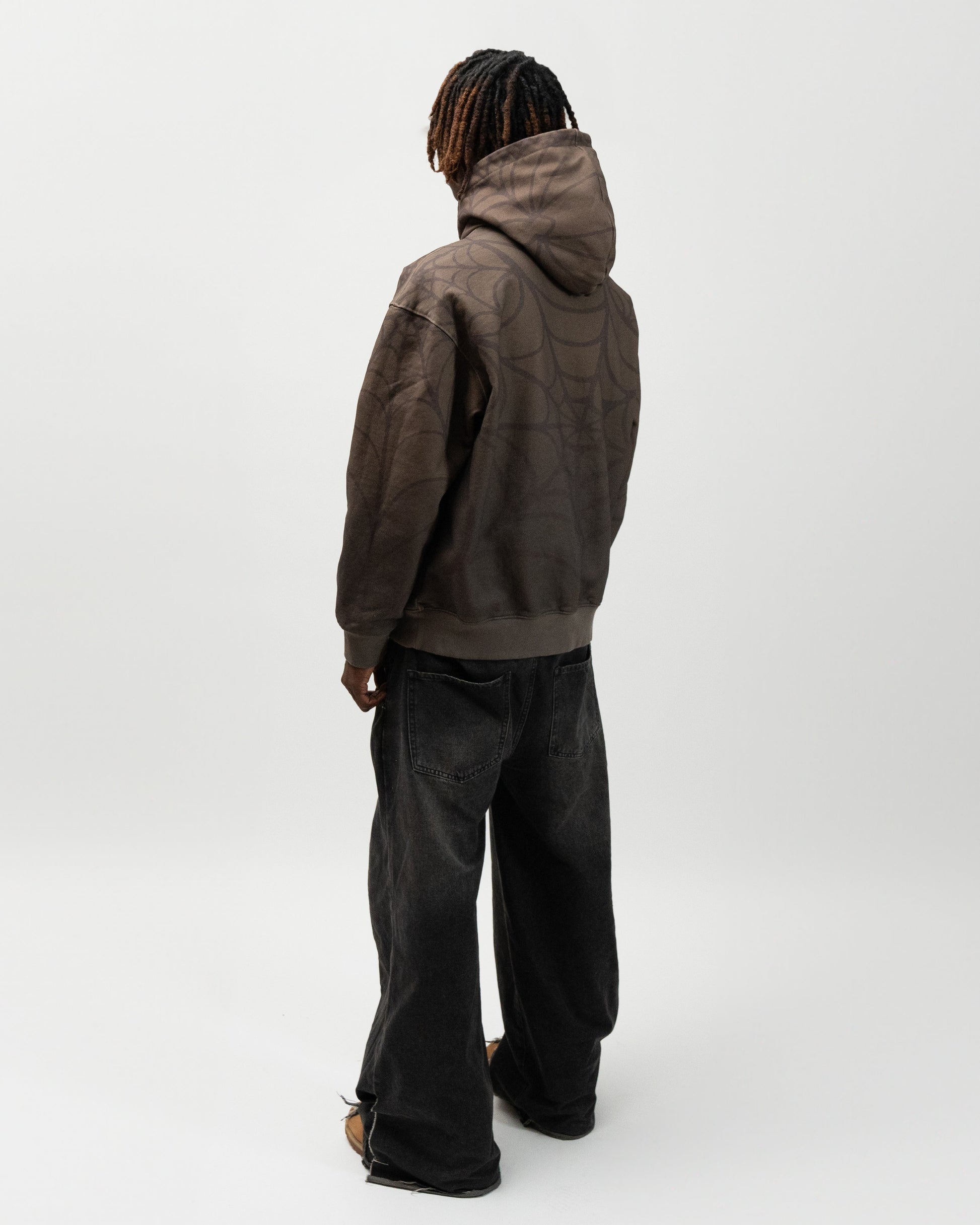 full back angle of the model. he is facing away from the camera. you can see the back of the hoodie and the hoodie. Spider hoodie by j3t