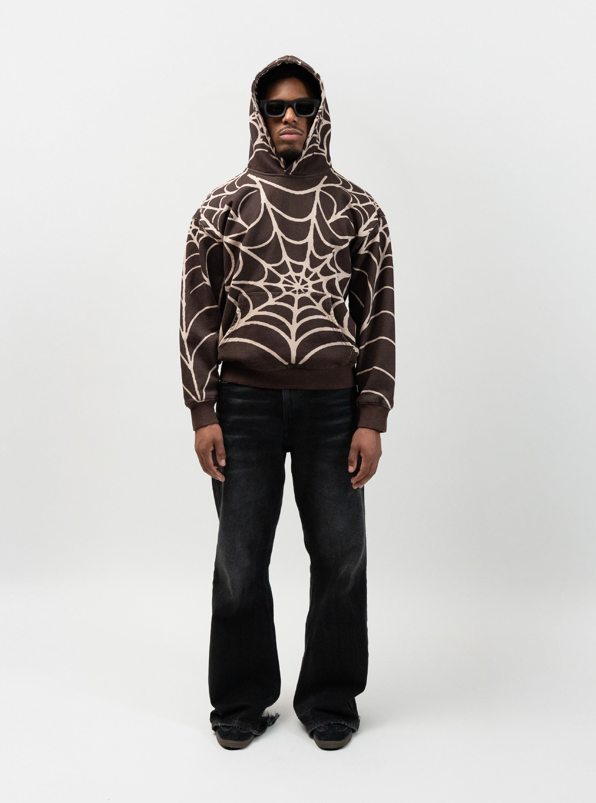 Full body angle of male model wearing the spider hoodie. no pose, hands down by his hip. everythingj3t