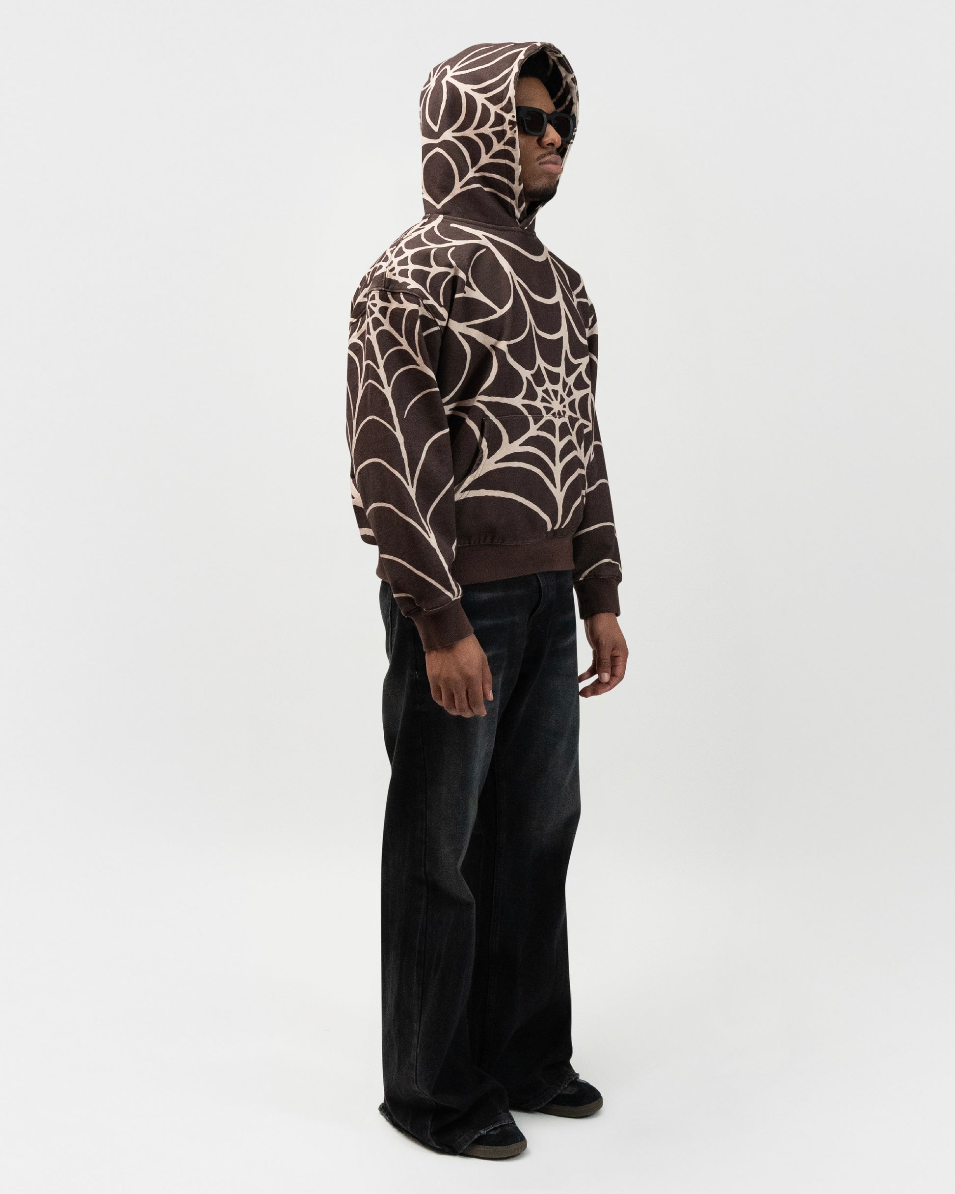 Full body angle of the model wearing the brown hoodie by J3T. He is facing 45 degrees to the right. j3t