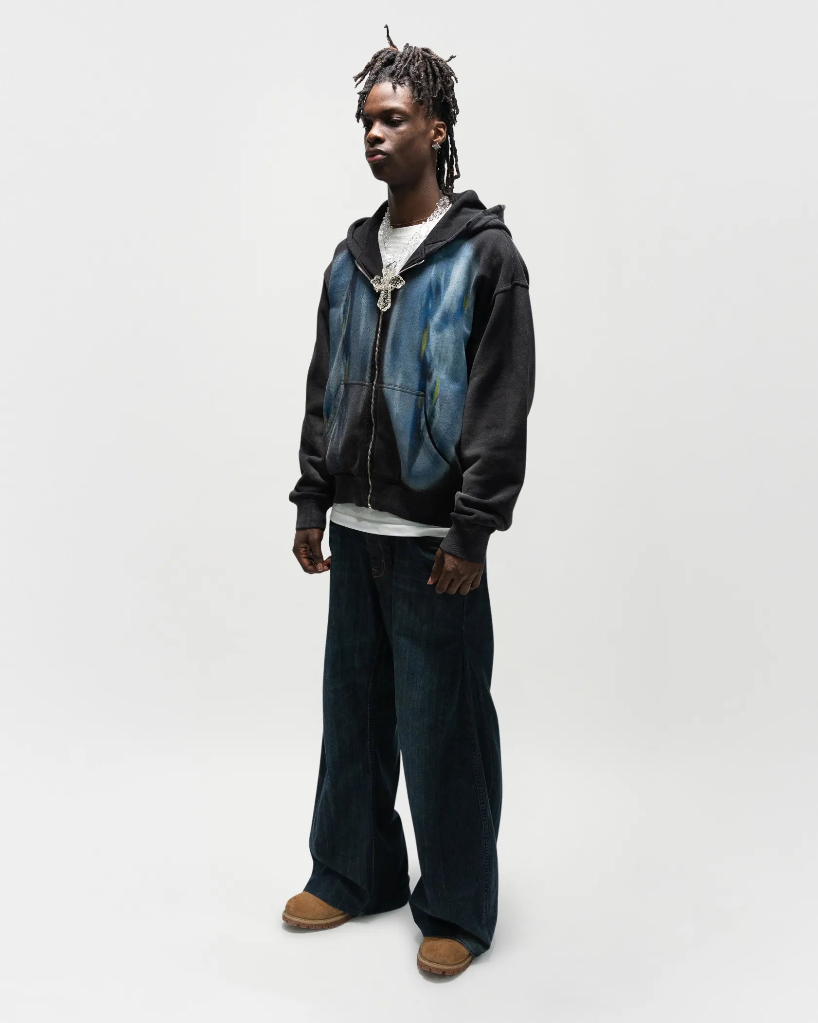 Black male model wearing the dogfight zip up by jet. This is a full body front/side view, 45 degree angle. everythingj3t