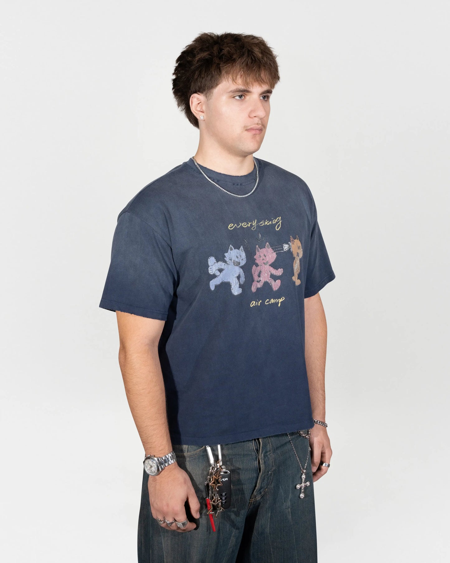half body shot of the model wearing the air camp tee. He is Facing towards the camera but at the 45 degree angle. J3T