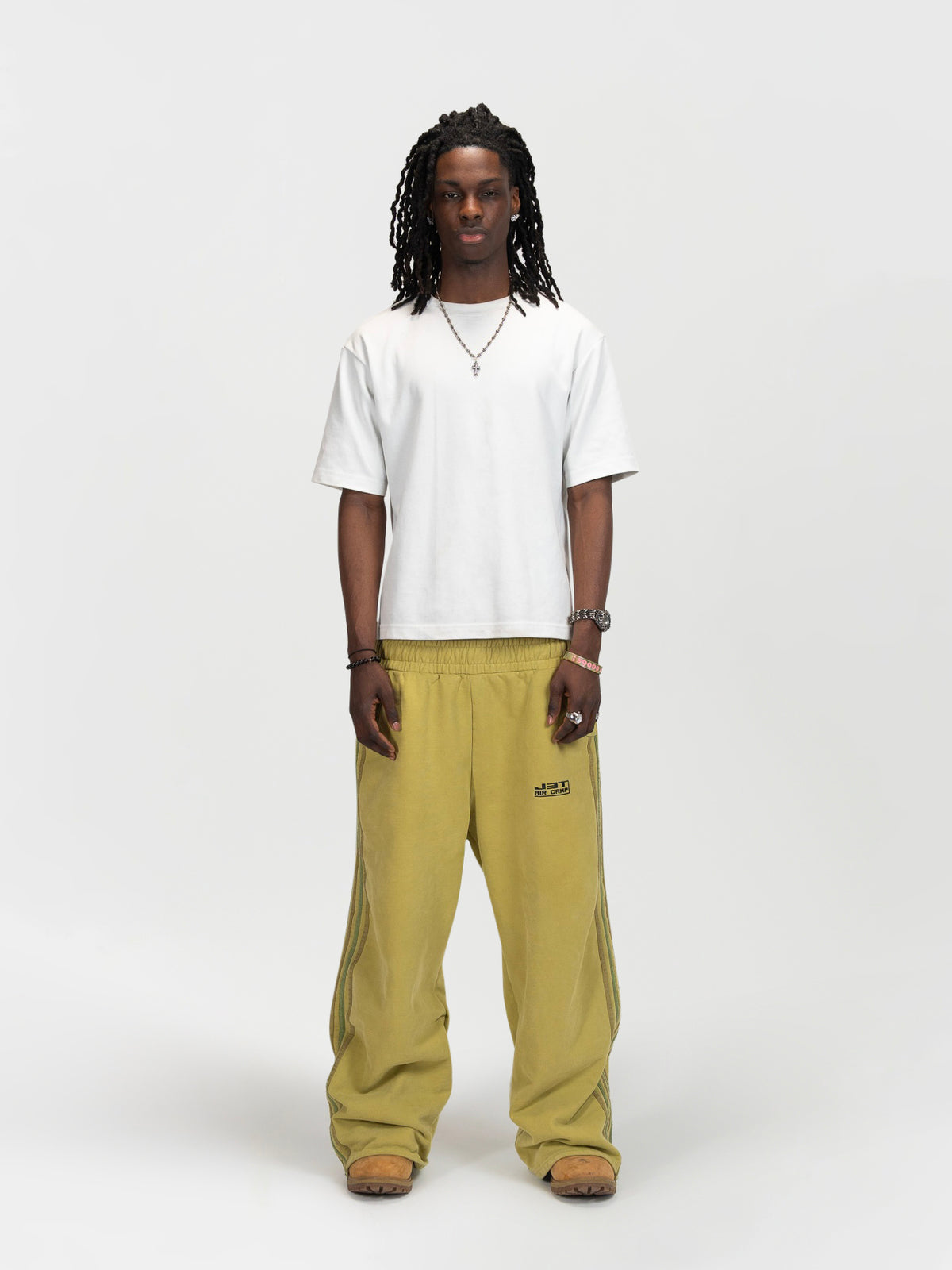 Front facing male model shot of the model wearing the matcha sweats by J3T. He has on a white shirt to complete the fit