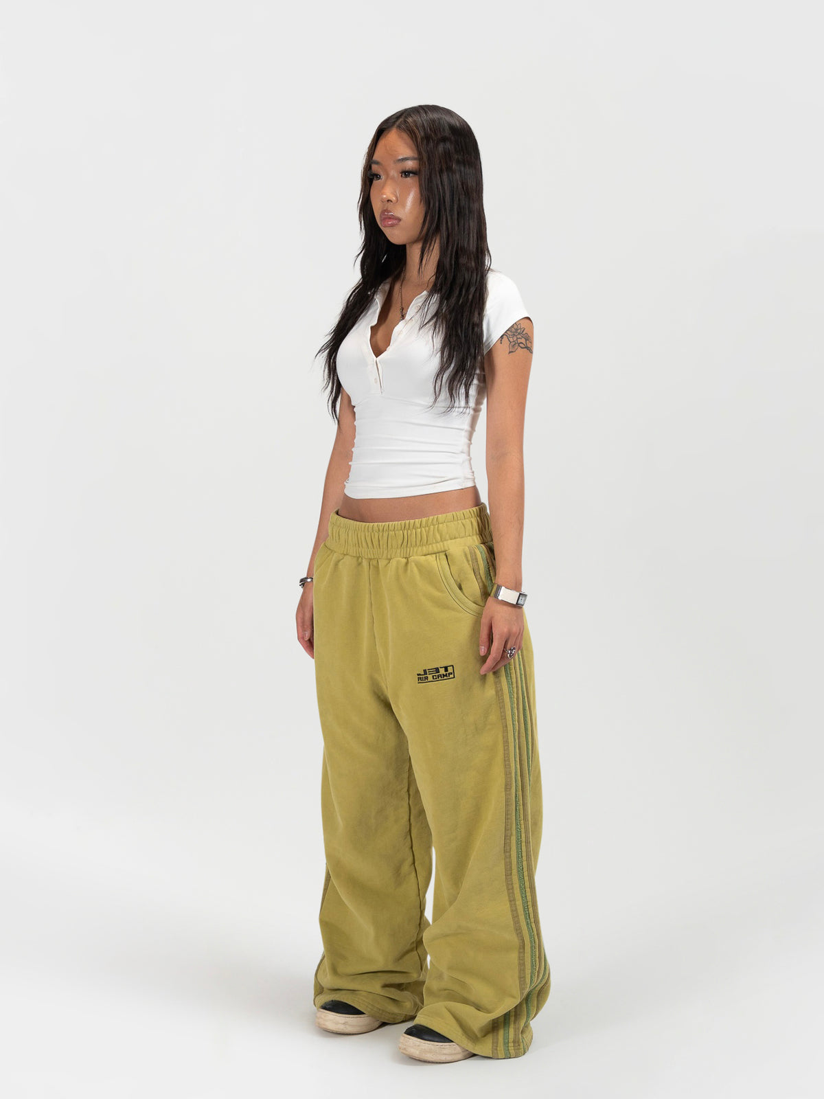 Left 45 degree facing female model shot of the model wearing the matcha sweats by J3T. She has on a white shirt to complete the fit
