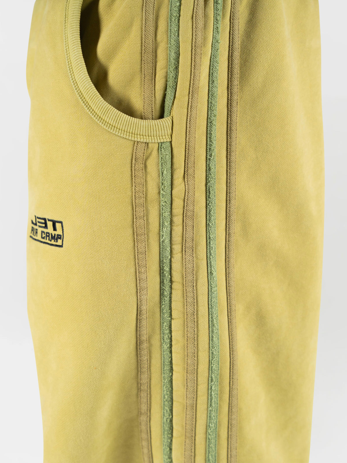 Very close-up side angle of the matcha sweatpants. Showing close up details of the side stripes and ribbed pocket. j3t apparel