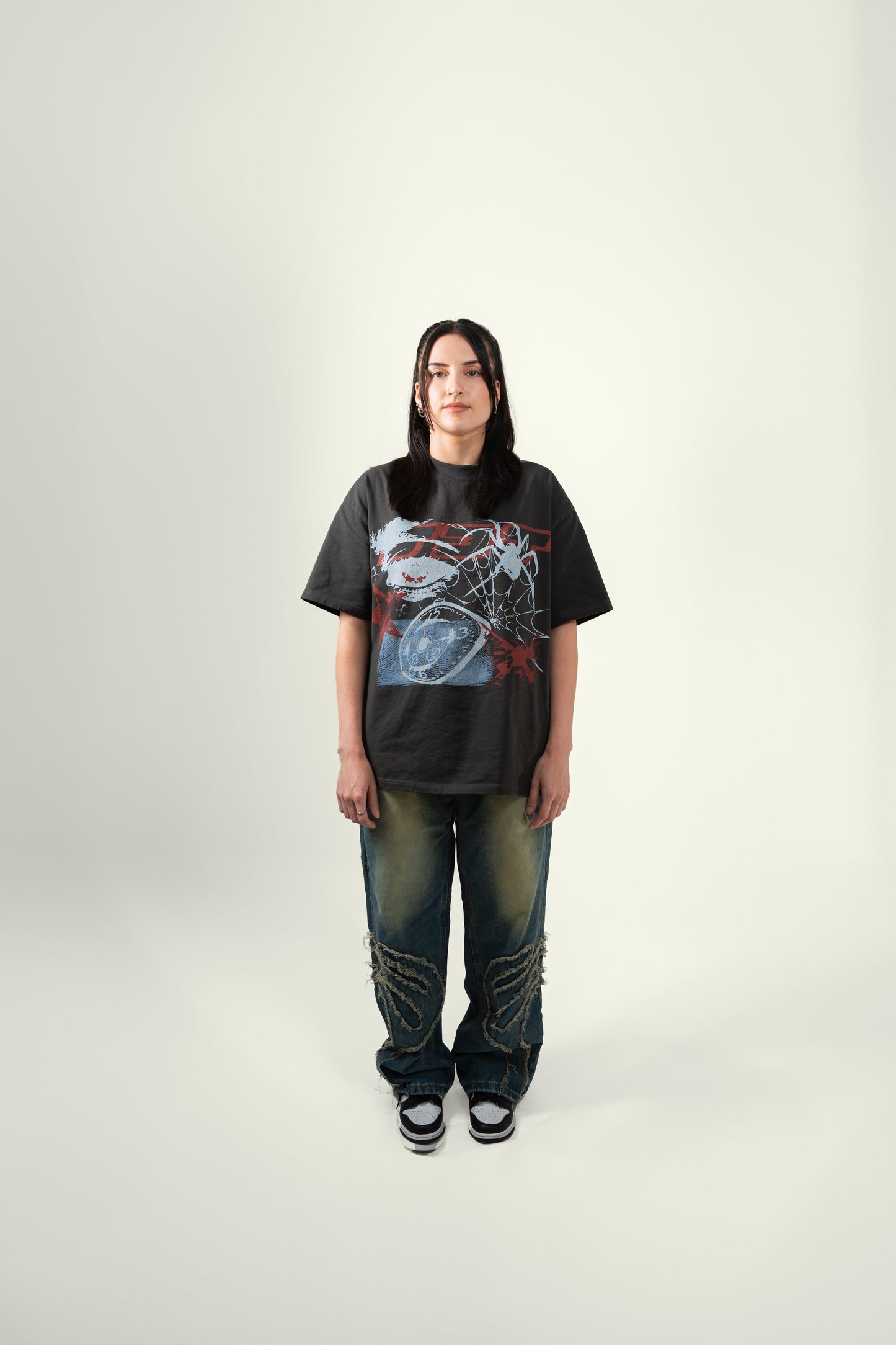 Full body angle of female model wearing the grey flock tee