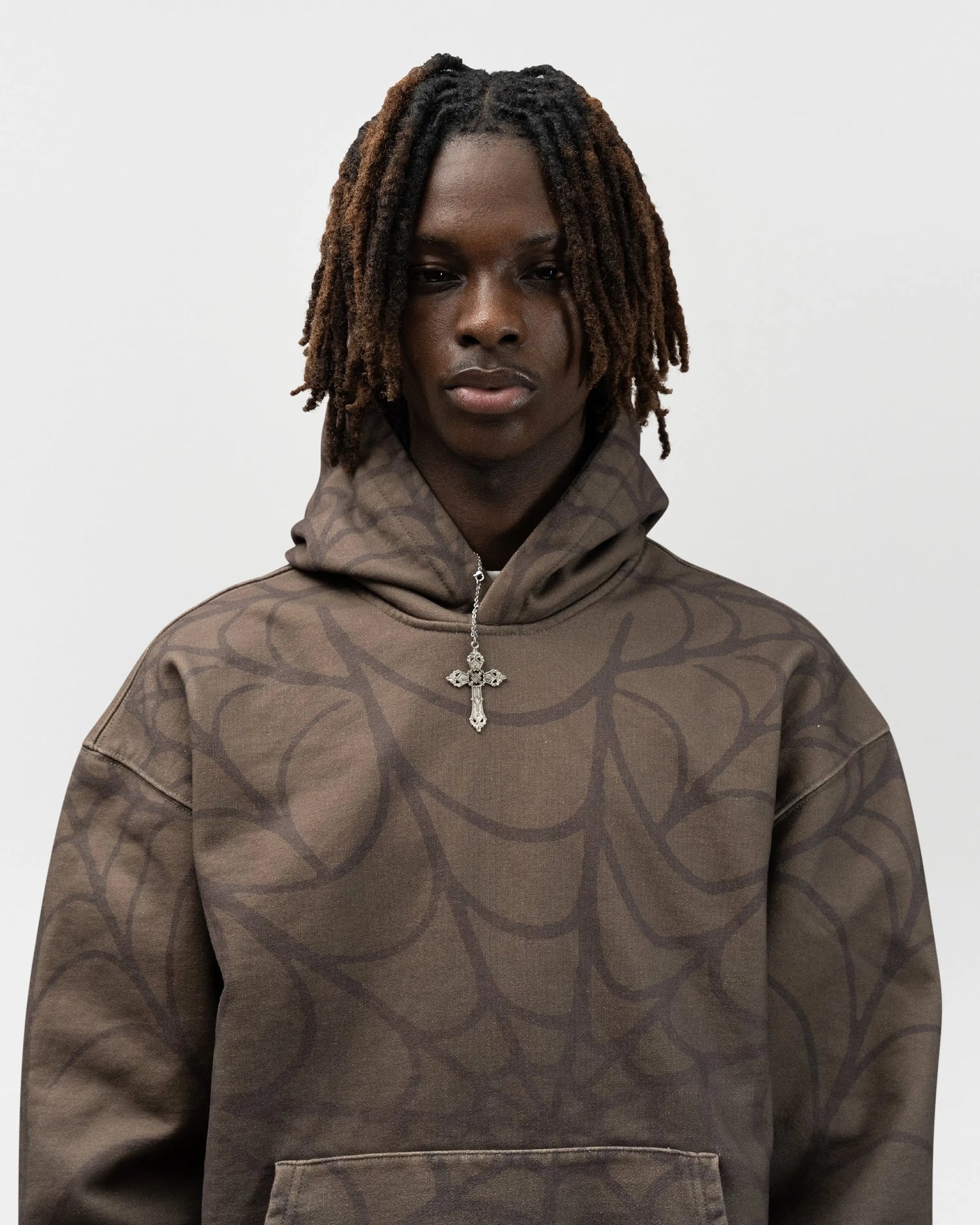 close up angle of male model wearing the green spider hoodie by everythingj3t. It is a half body shot. jet