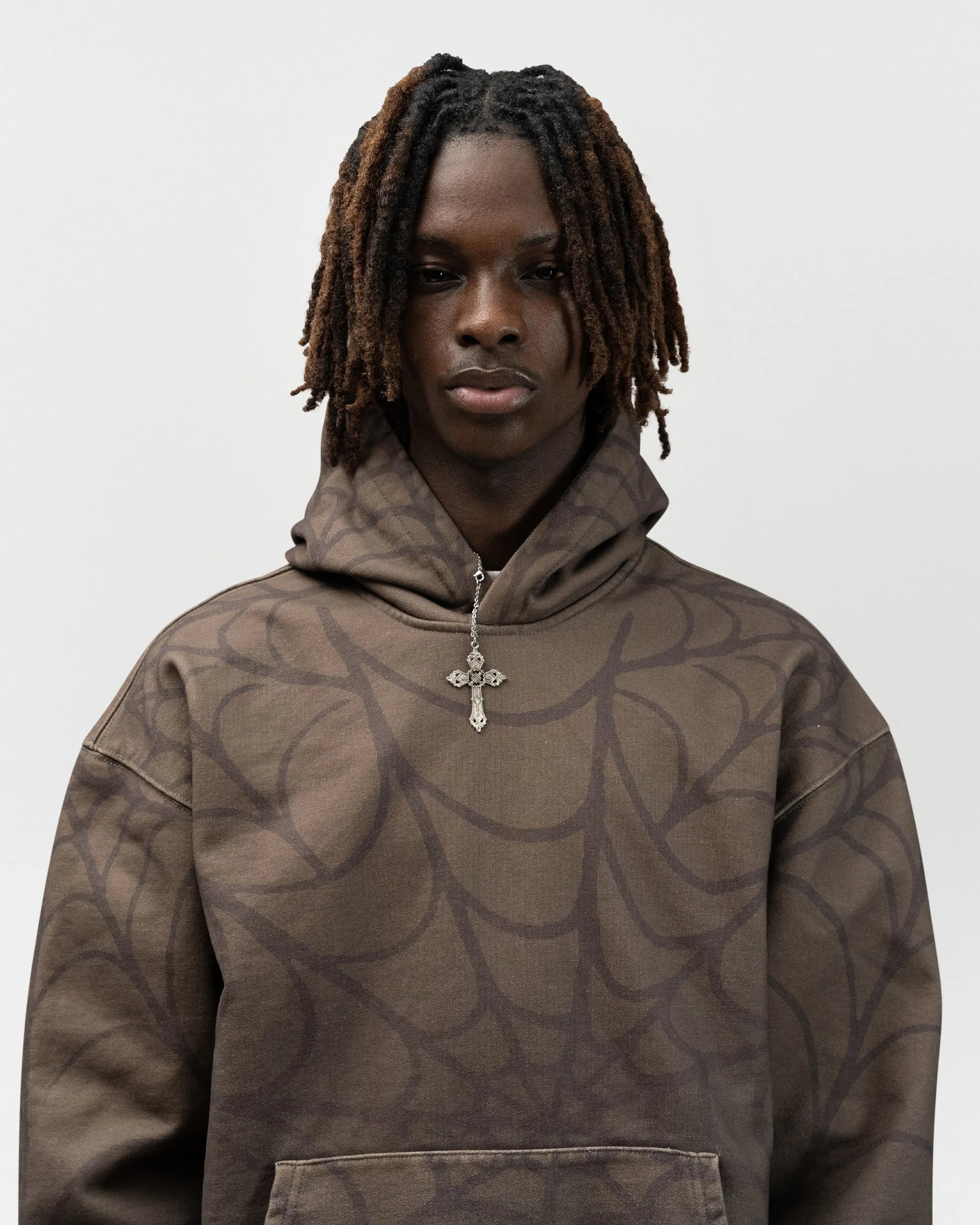 close up angle of male model wearing the green spider hoodie by everythingj3t. It is a half body shot. jet