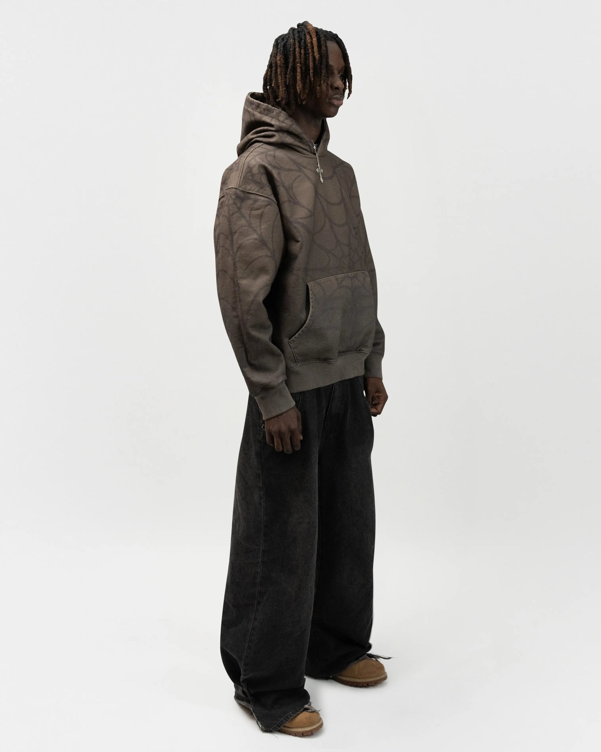 Full body angle of the model wearing the spider hoodie by J3T. He is facing 45 degrees to the right. j3t