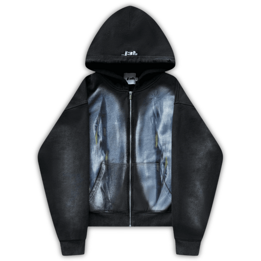 Flat lay image of the dogfight zip up. Two large oval print of fighter jets is visible on both side of the zipper. The hoodie is black and has vintage wash and distressing. J3T